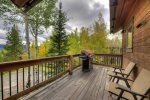 A gas grill on the front deck with views of aspen trees and the Continental Divide 